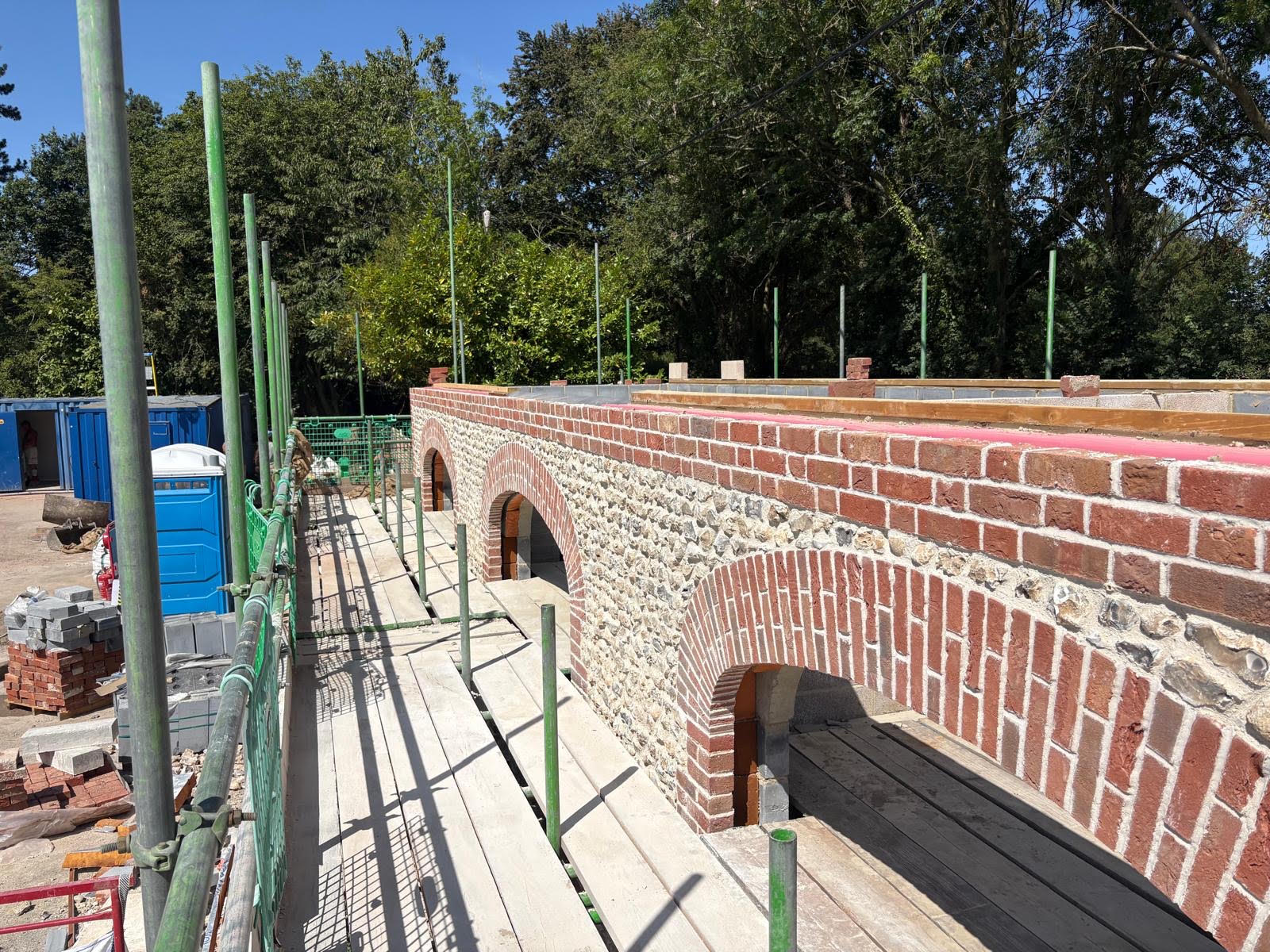 Brick and flint arched bridge under construction