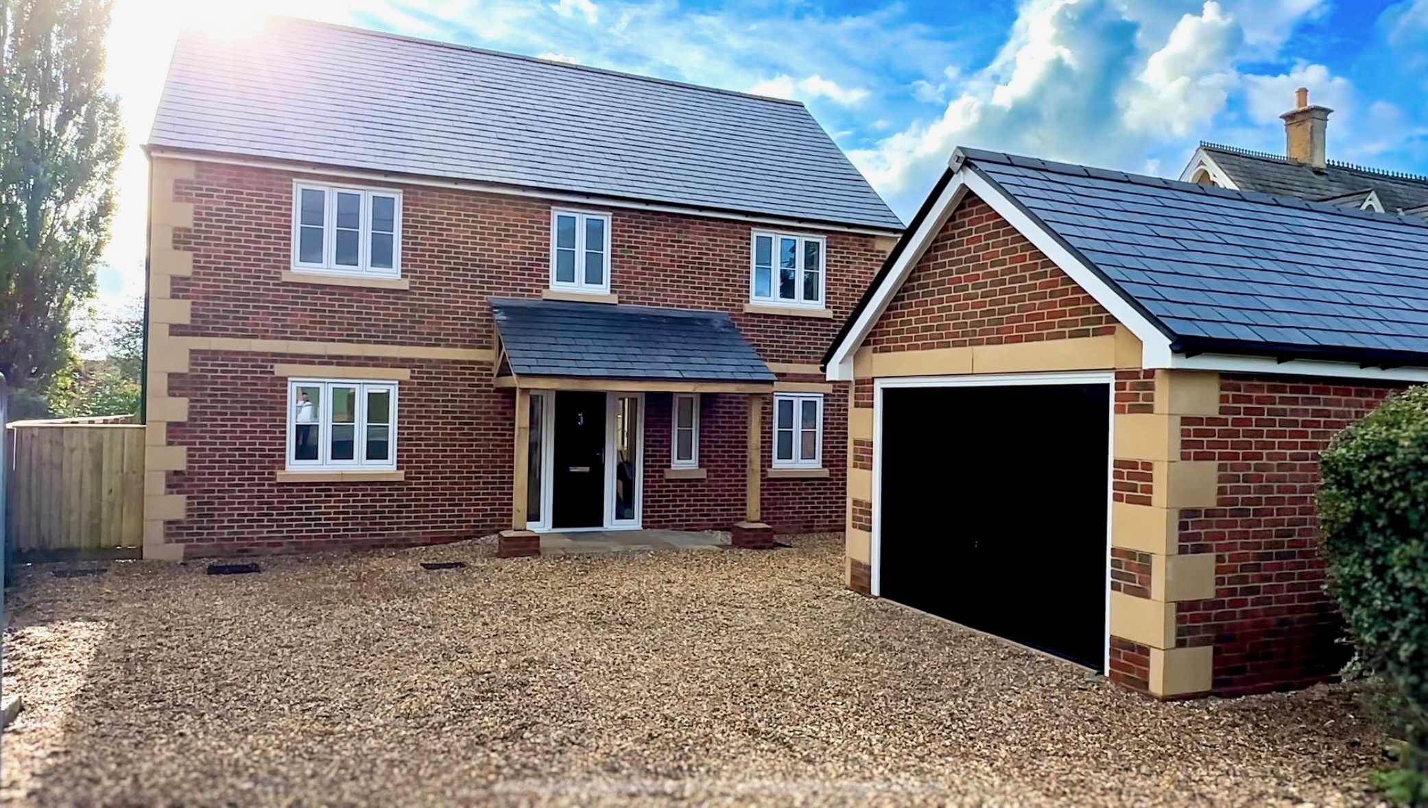 Brick house with slate roof and double garage